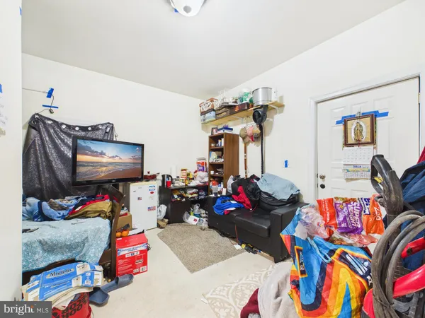a bedroom with furniture and a gym equipment