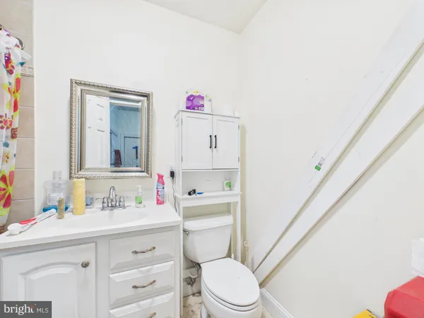 a bathroom with a sink a toilet a vanity and mirror