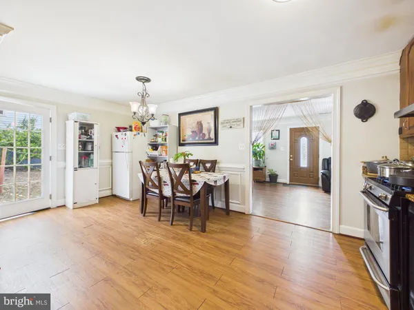 a view of a dining room with furniture and chandelier