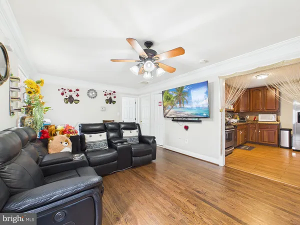 a living room with furniture and kitchen view