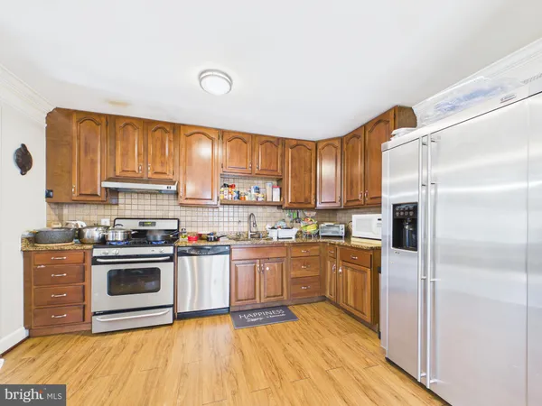 a kitchen with stainless steel appliances granite countertop a stove and a refrigerator