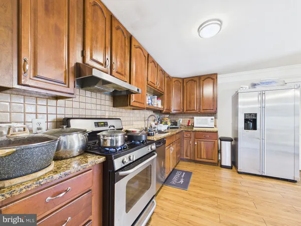 a kitchen with stainless steel appliances granite countertop a stove and a sink