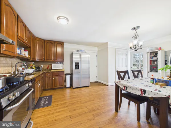 a kitchen with stainless steel appliances granite countertop a stove refrigerator and cabinets