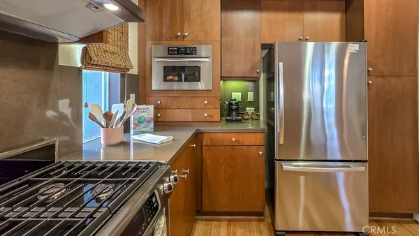 a kitchen with granite countertop wooden cabinets and white appliances