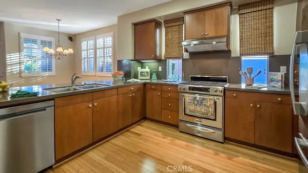 a kitchen with wooden cabinets and stainless steel appliances