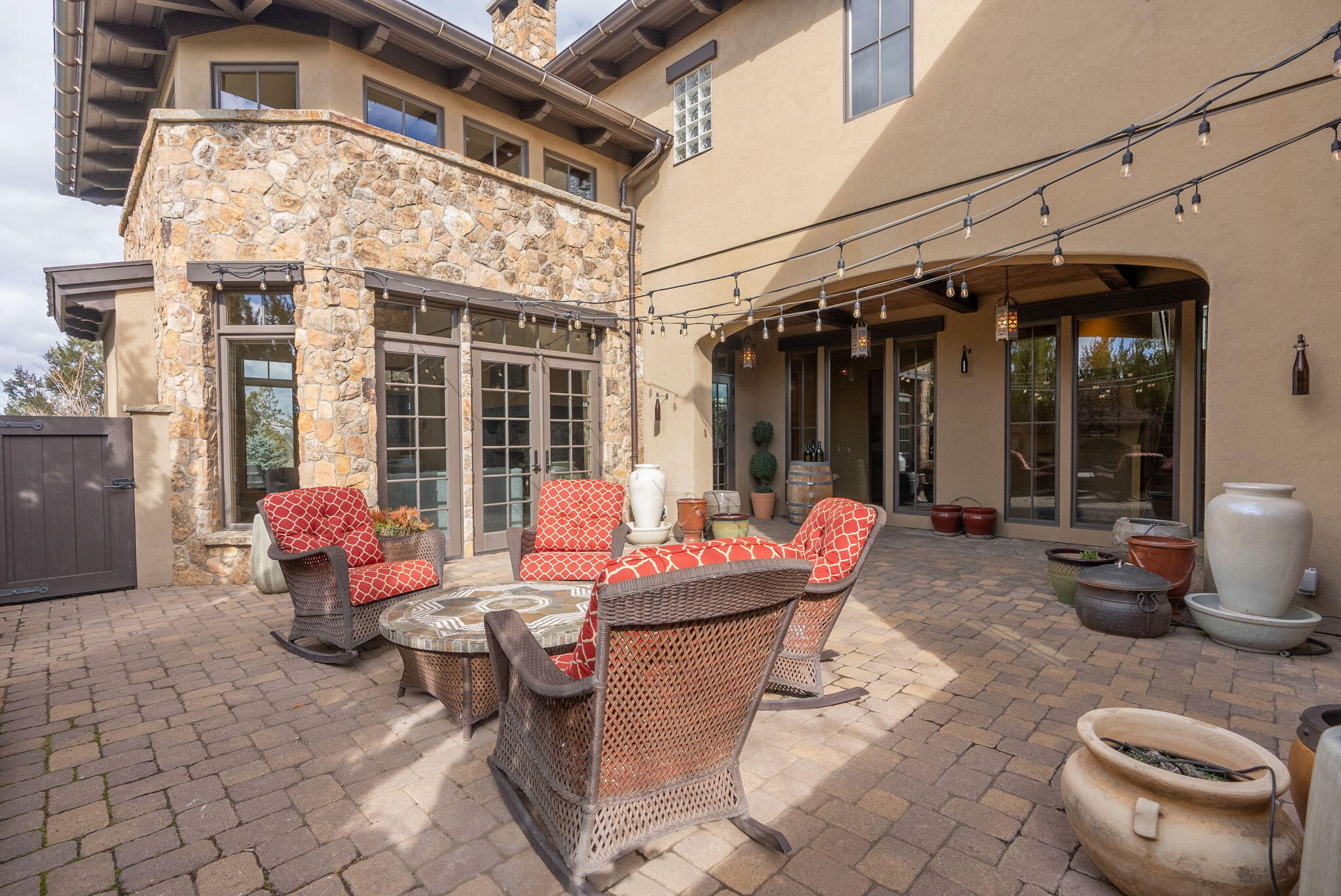 22887 Ghost Tree Lane Bend, OR 97701 - Photo 26 of 97 Multiple French doors open to a paver patio courtyard, complete with fireplace.