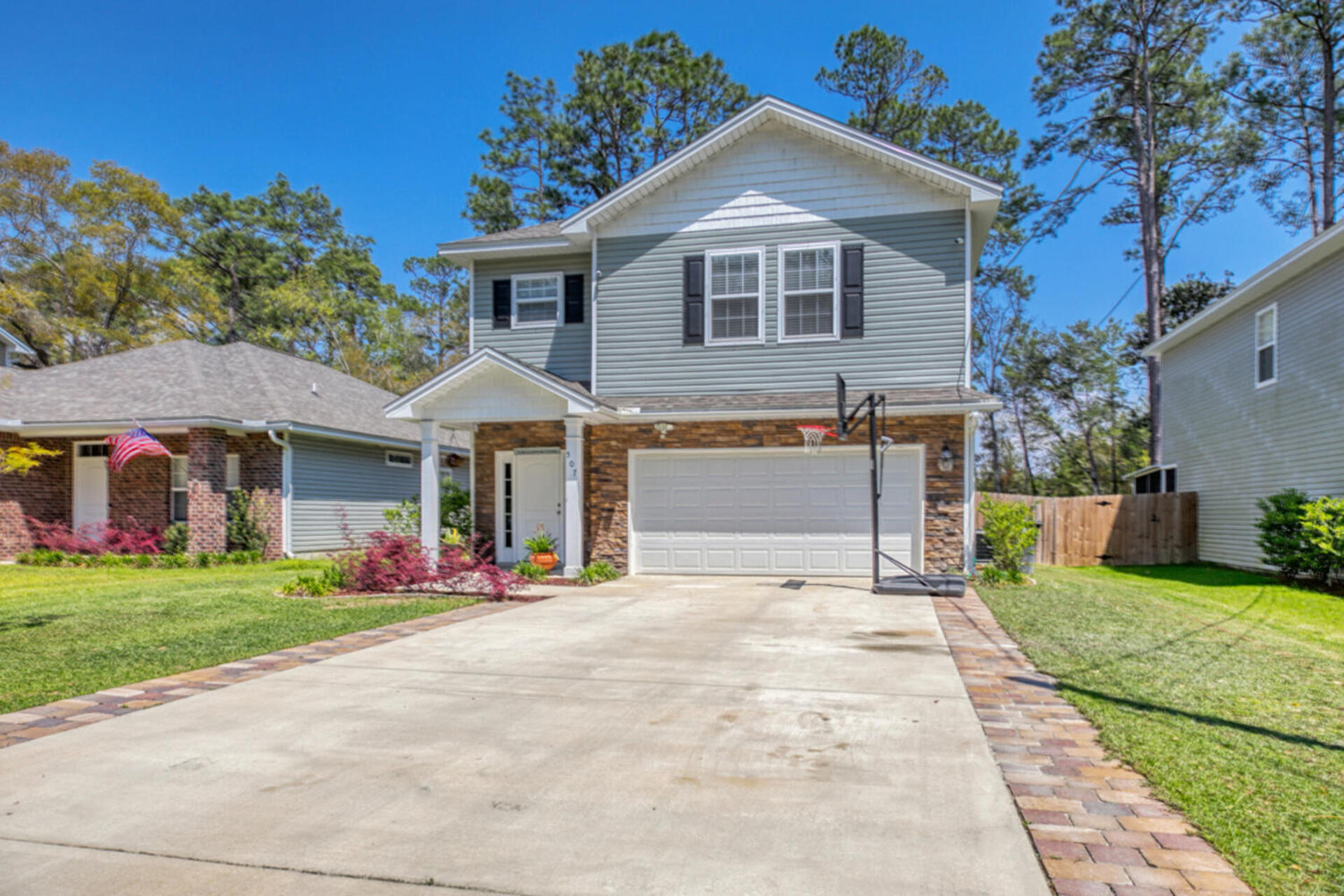 507 Johnson Street Valparaiso, FL 32580 - Photo 1 of 40 a front view of a house with a yard and garage