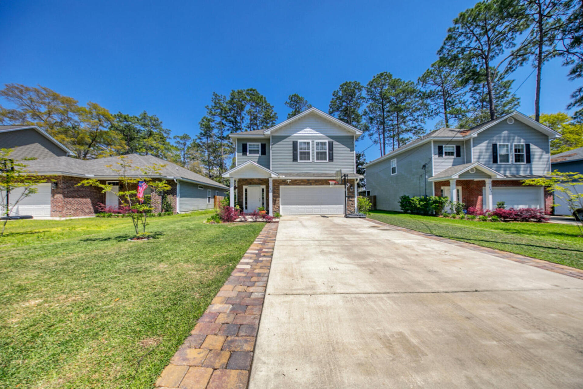 507 Johnson Street Valparaiso, FL 32580 - Photo 2 of 40 a front view of a house with a yard and potted plants