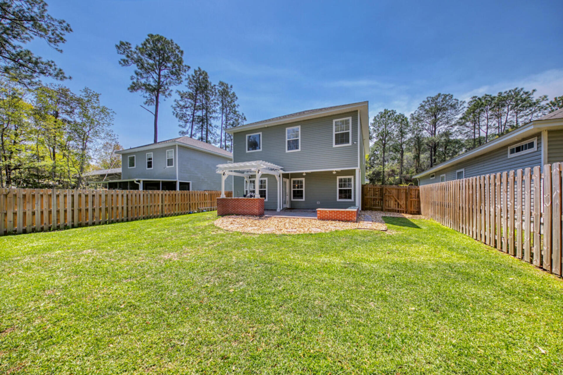 507 Johnson Street Valparaiso, FL 32580 - Photo 22 of 40 a view of a house with backyard and a tree