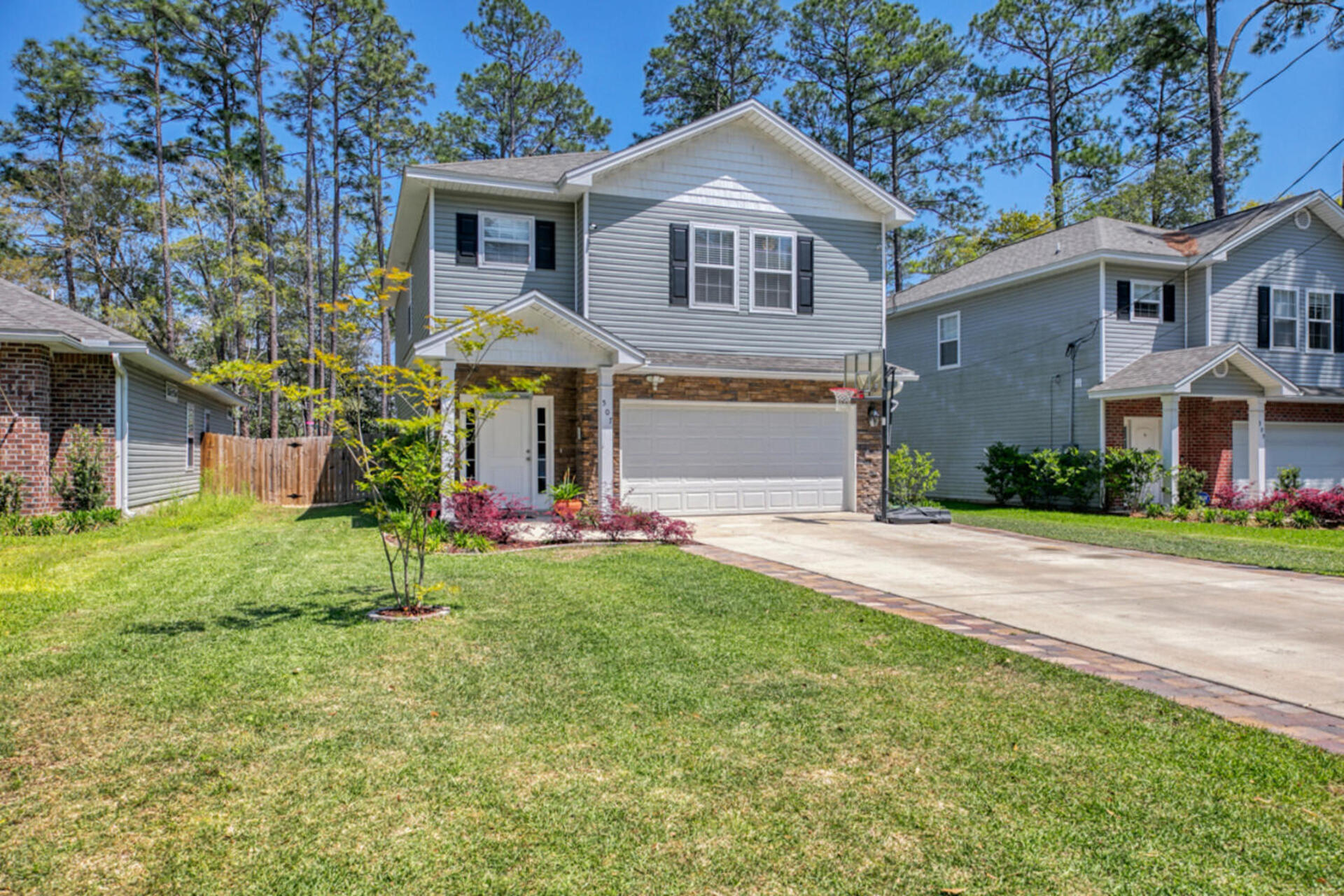 507 Johnson Street Valparaiso, FL 32580 - Photo 3 of 40 a front view of a house with a yard and trees