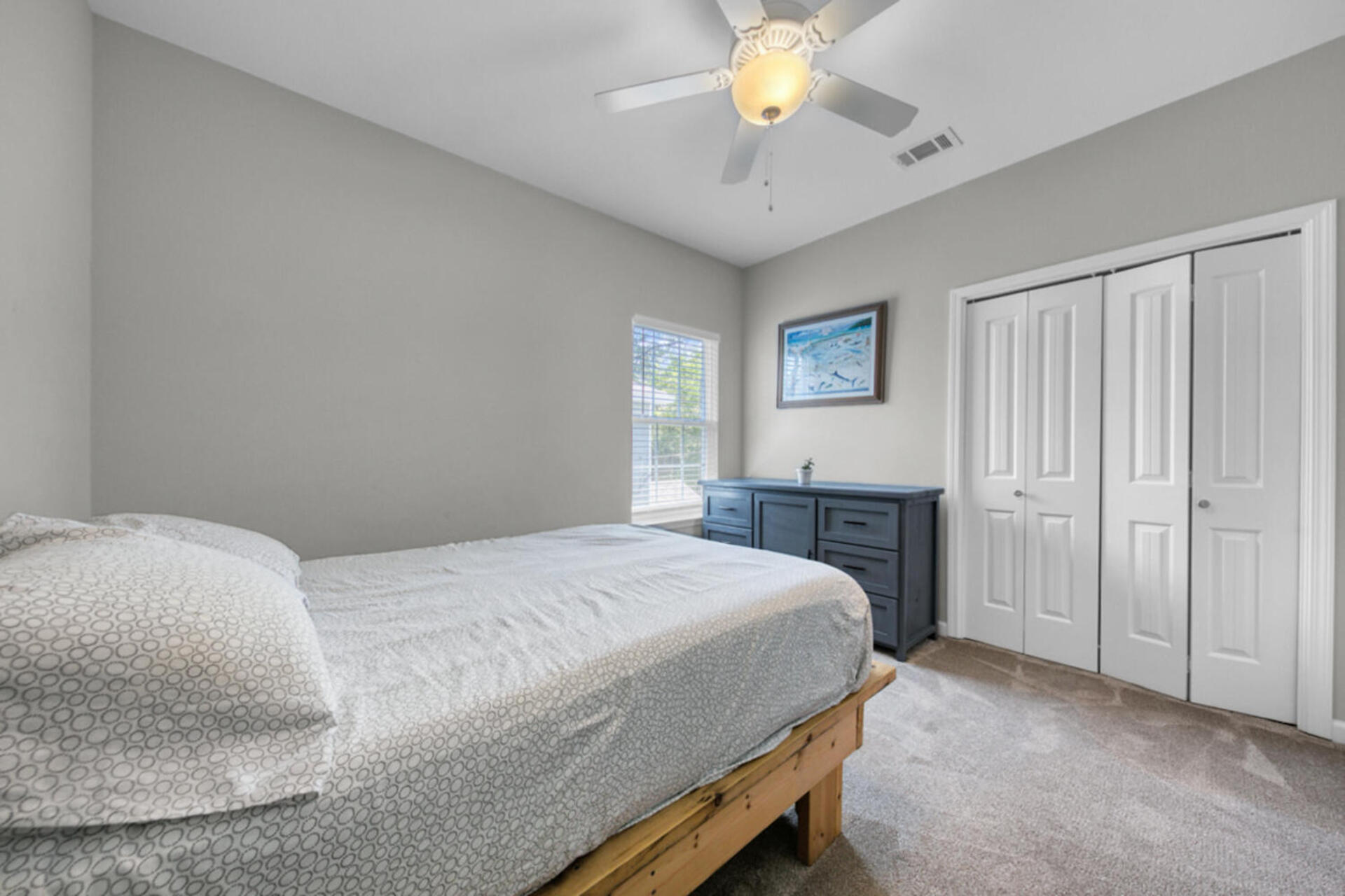 507 Johnson Street Valparaiso, FL 32580 - Photo 35 of 40 a bedroom with a bed and a chandelier