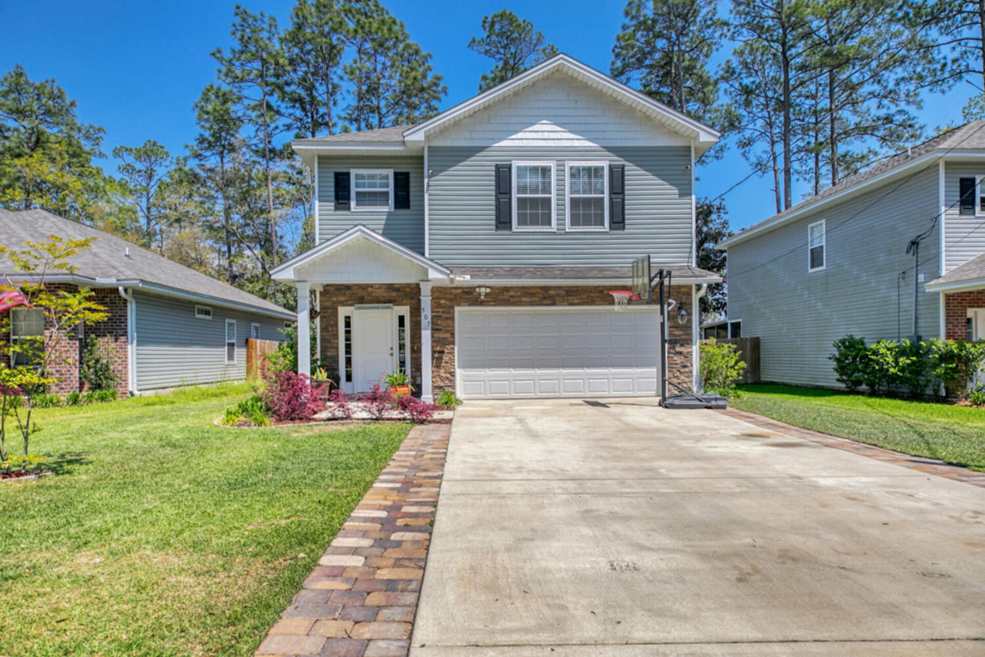 507 Johnson Street Valparaiso, FL 32580 - Photo 4 of 40 a front view of a house with a yard and garage