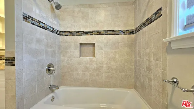 a bathroom with a shower and a bathtub