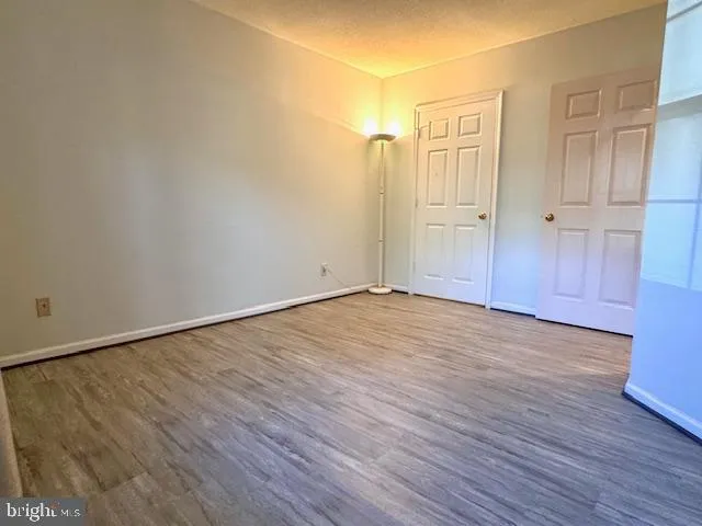 an empty room with wooden floor
