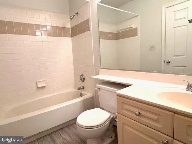 a spacious bathroom with a toilet sink and mirror