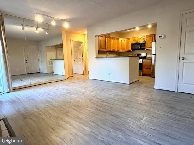 a view of a kitchen with wooden floor and a sink