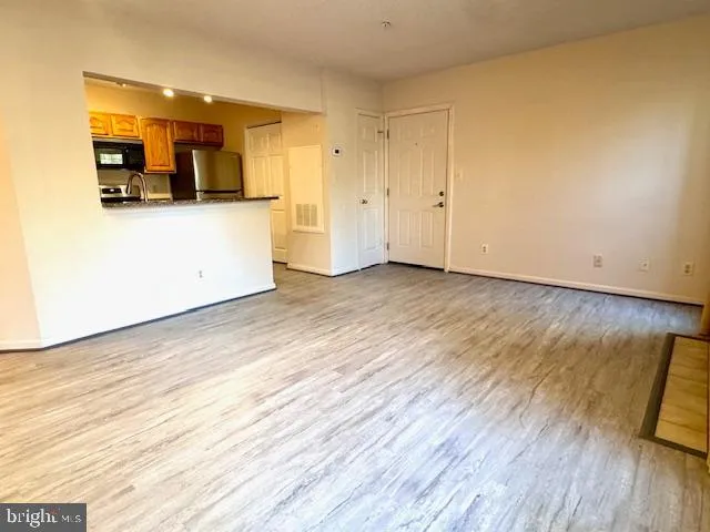 a kitchen with stainless steel appliances granite countertop a refrigerator stove microwave and sink