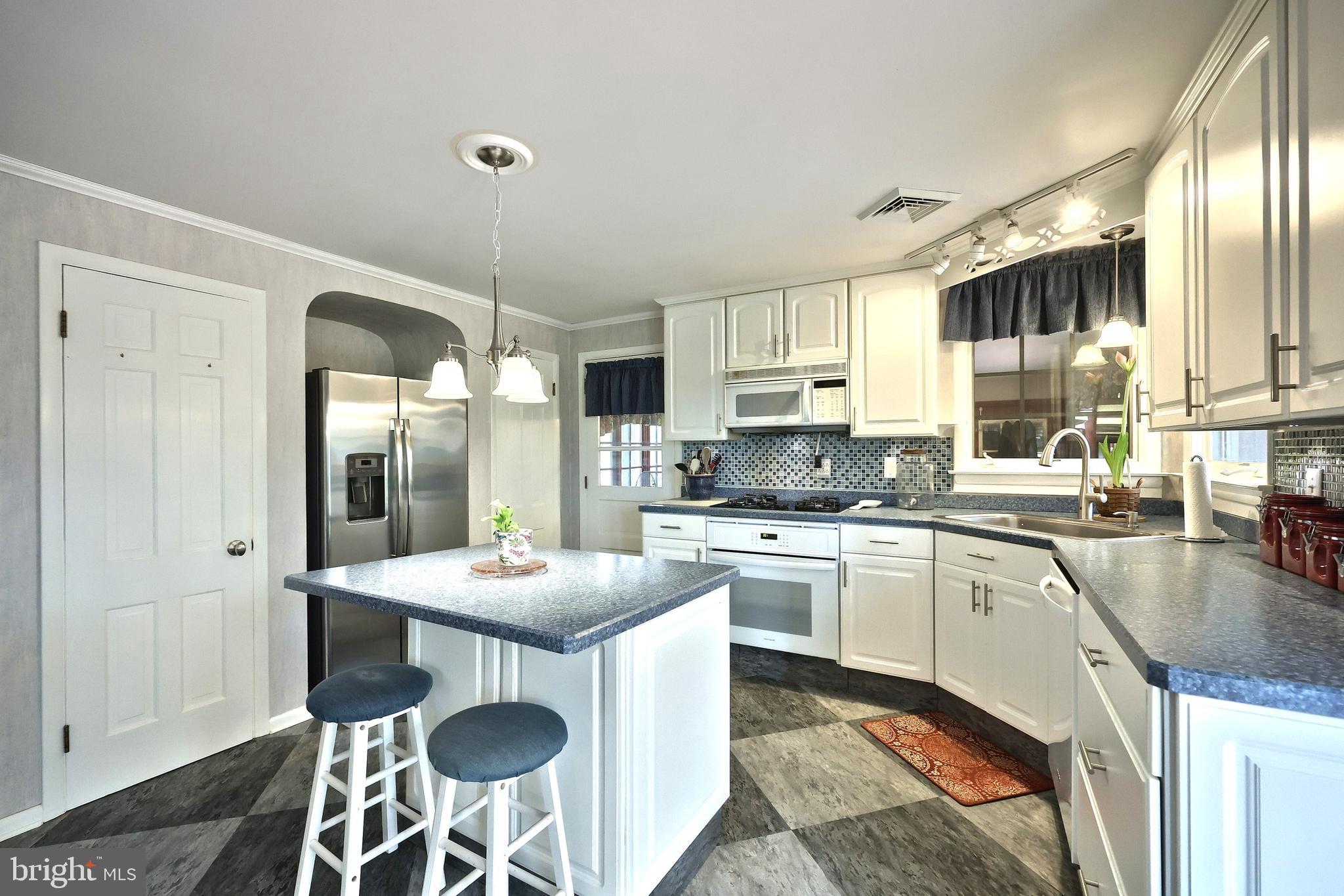 4204 Grandview Road Hanover, PA 17331 - Photo 26 of 77 a kitchen with stainless steel appliances granite countertop a sink a stove a refrigerator a oven a dining table and chairs