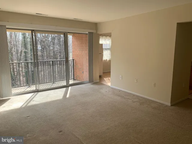 a view of empty room with floor to ceiling window