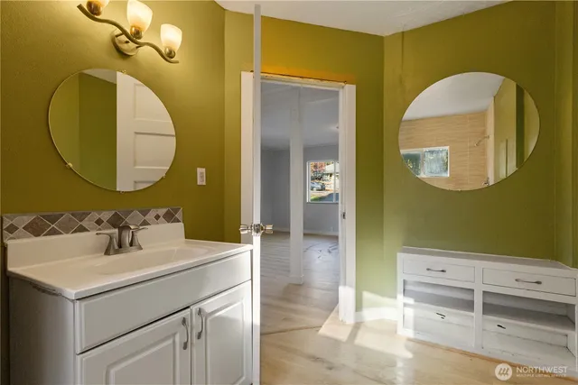 a bathroom with a sink mirror and vanity