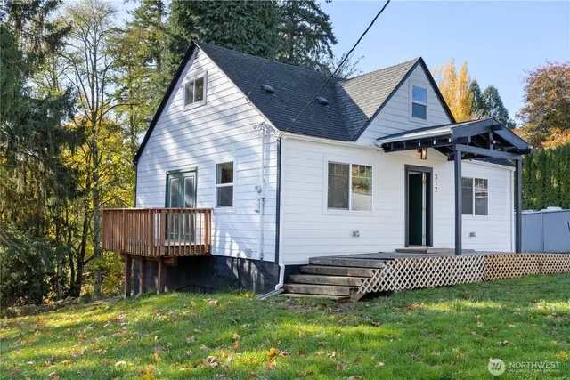 a view of a house with a yard and deck