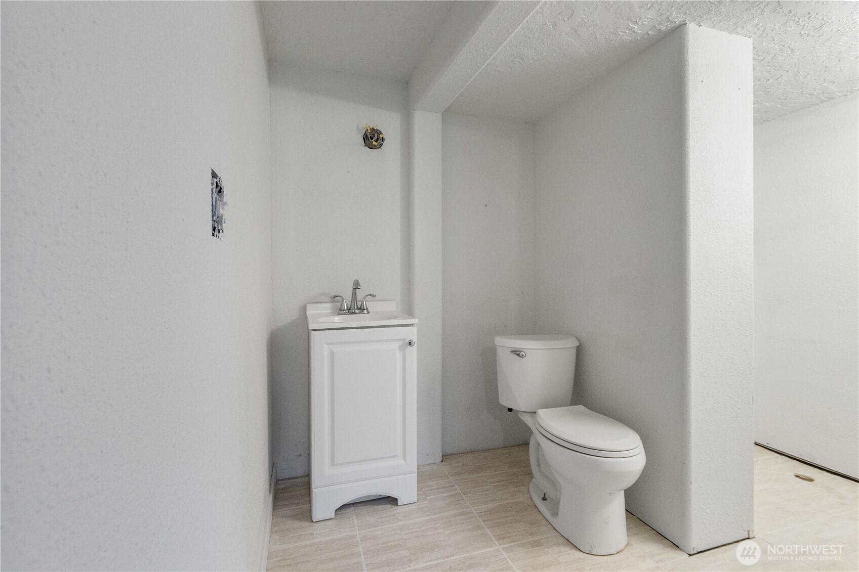 312 Nevada Drive Longview, WA 98632 - Photo 21 of 27 a white toilet sitting next to a bathroom sink