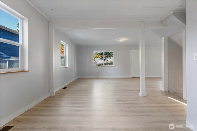 wooden floor in an empty room with a window