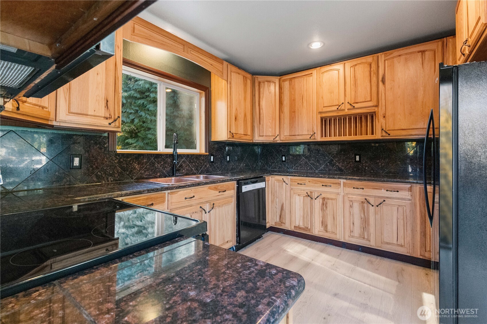 312 Nevada Drive Longview, WA 98632 - Photo 6 of 27 a kitchen with granite countertop a stove a sink and a microwave