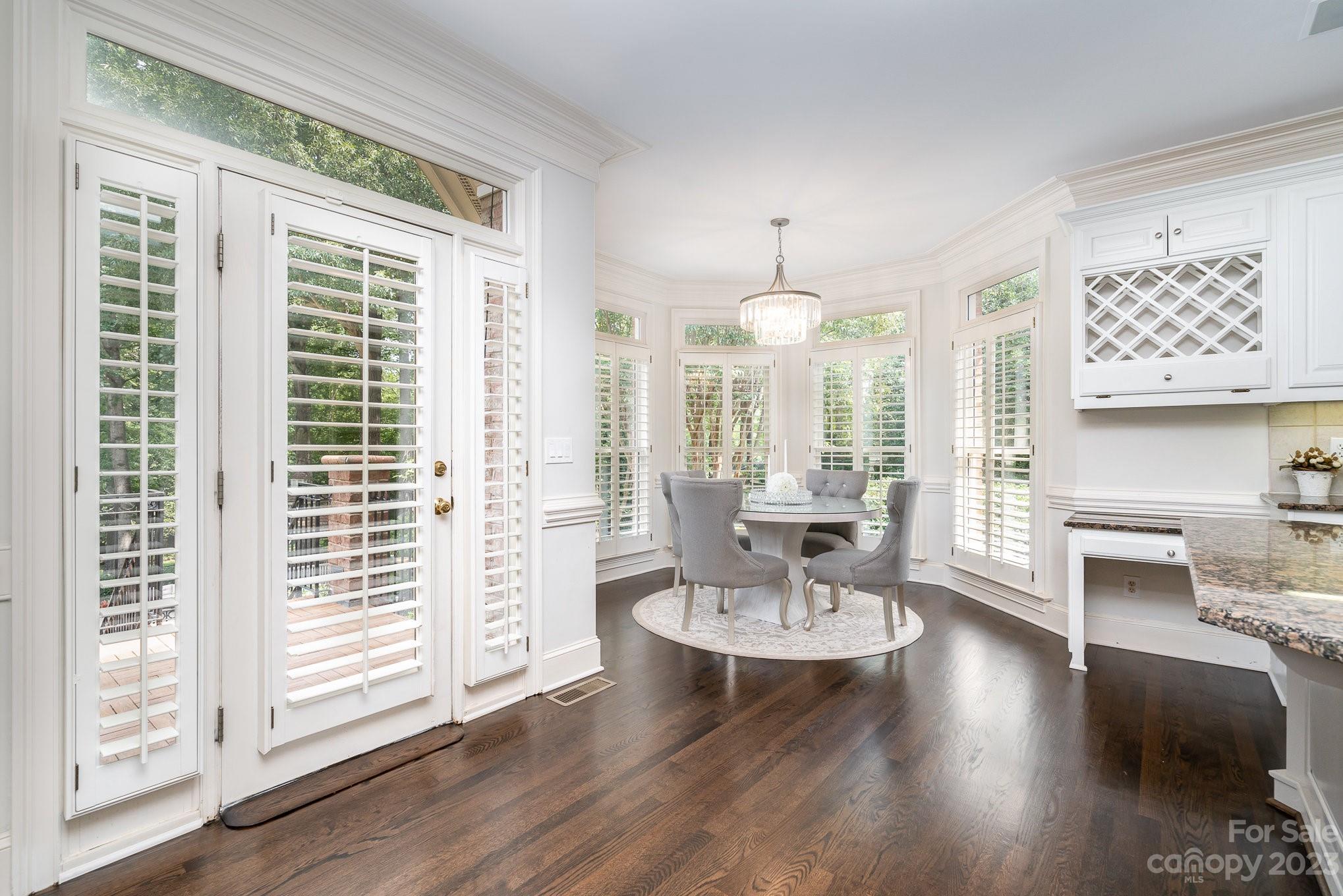 6535 Seton House Lane Charlotte, NC 28277 - Photo 12 of 48 a view of a dining room with furniture window and wooden floor