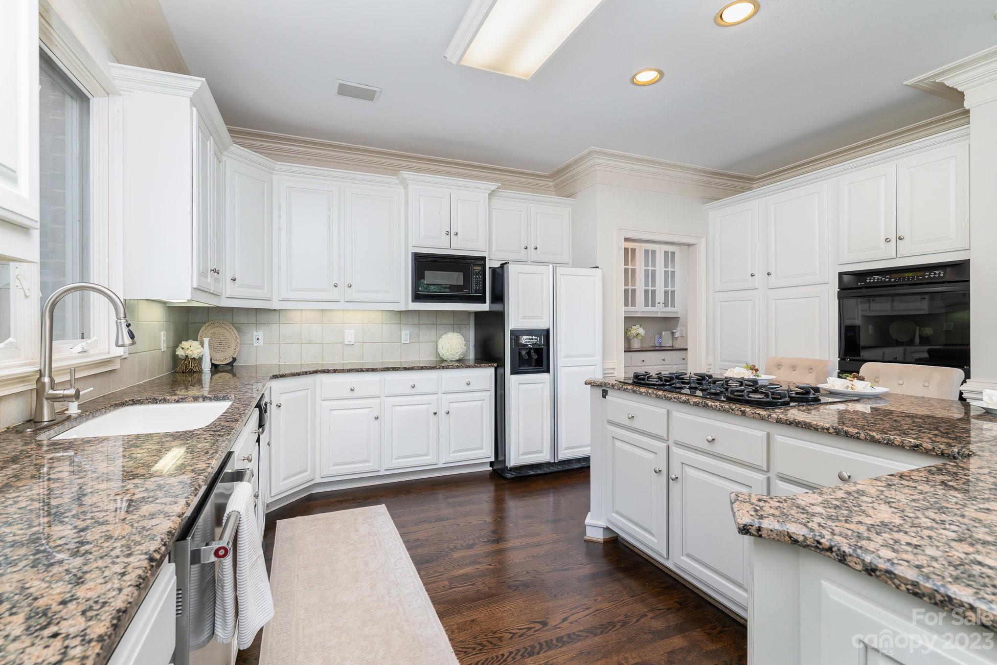 6535 Seton House Lane Charlotte, NC 28277 - Photo 15 of 48 a kitchen with stainless steel appliances granite countertop a stove sink and cabinets