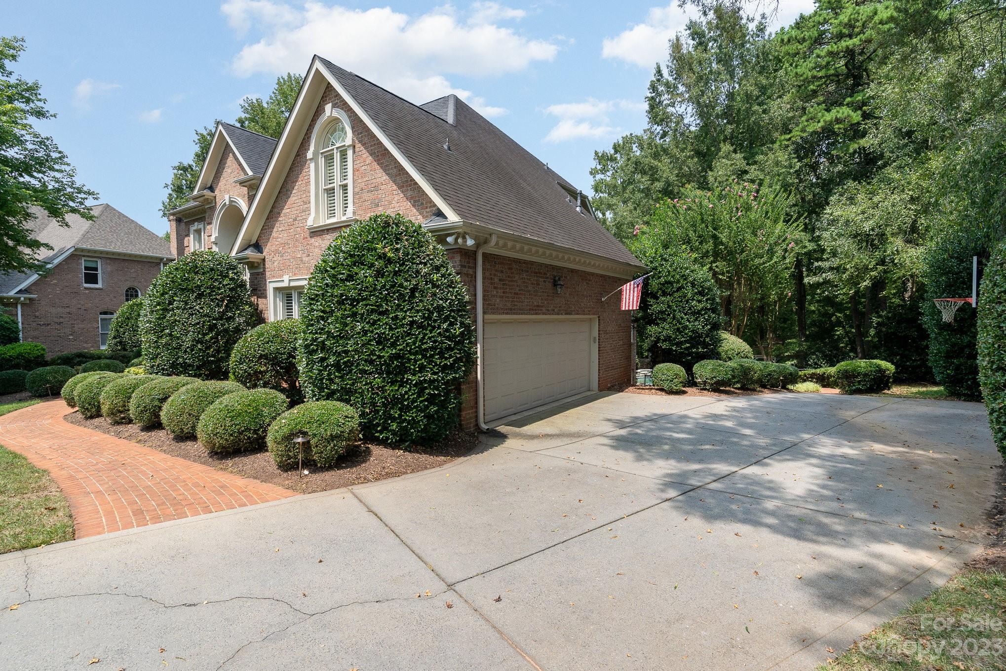 6535 Seton House Lane Charlotte, NC 28277 - Photo 3 of 48 a front view of a house with a yard and garage