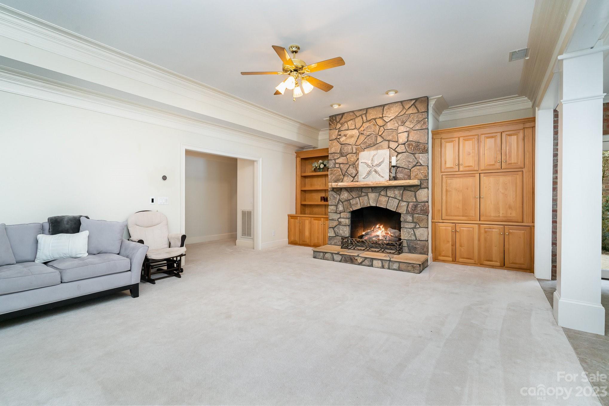 6535 Seton House Lane Charlotte, NC 28277 - Photo 31 of 48 a living room with furniture and a fireplace