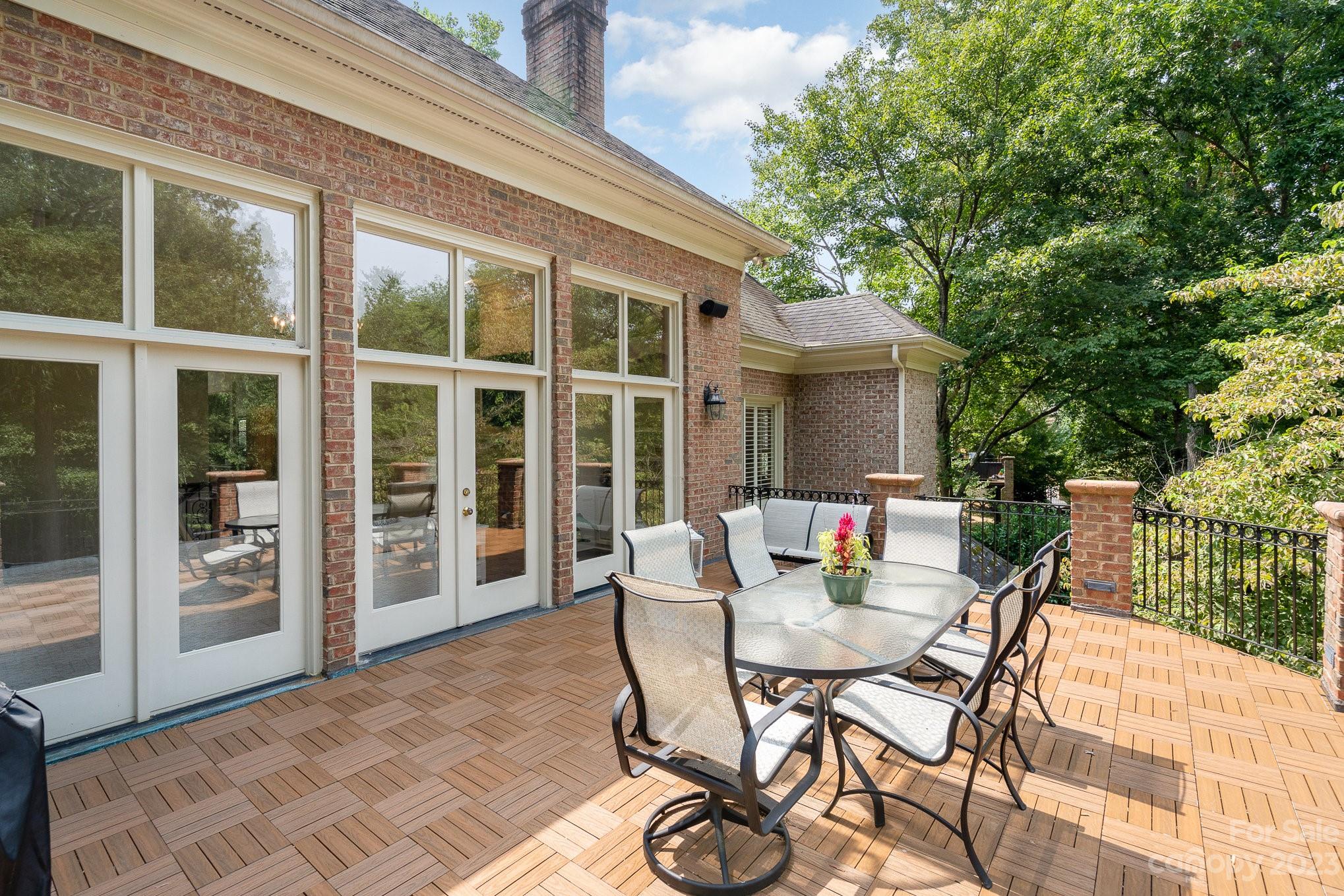 6535 Seton House Lane Charlotte, NC 28277 - Photo 39 of 48 a view of a patio with a dining table and chairs with wooden floor and fence