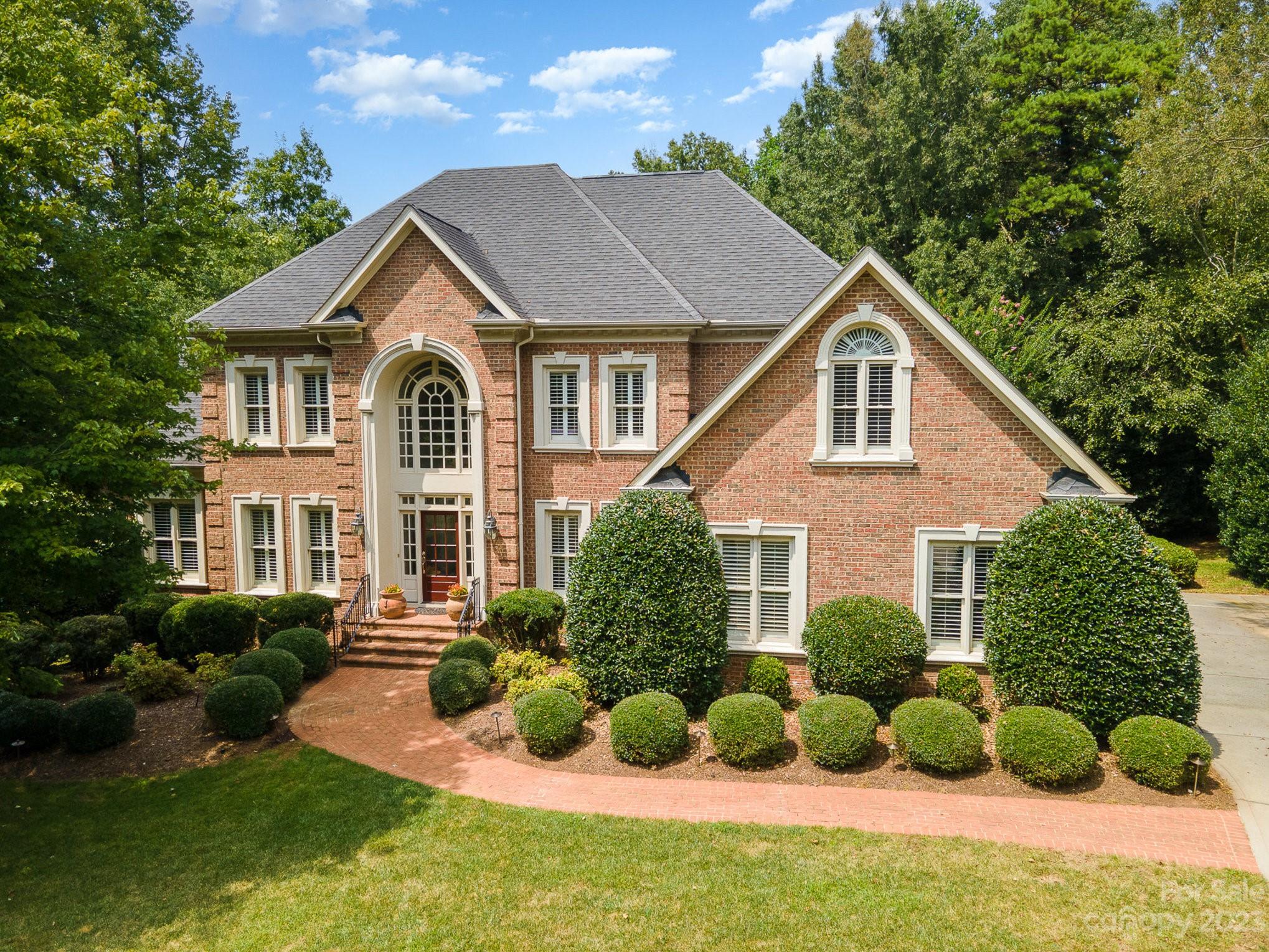 6535 Seton House Lane Charlotte, NC 28277 - Photo 46 of 48 a front view of a house with a yard and plants