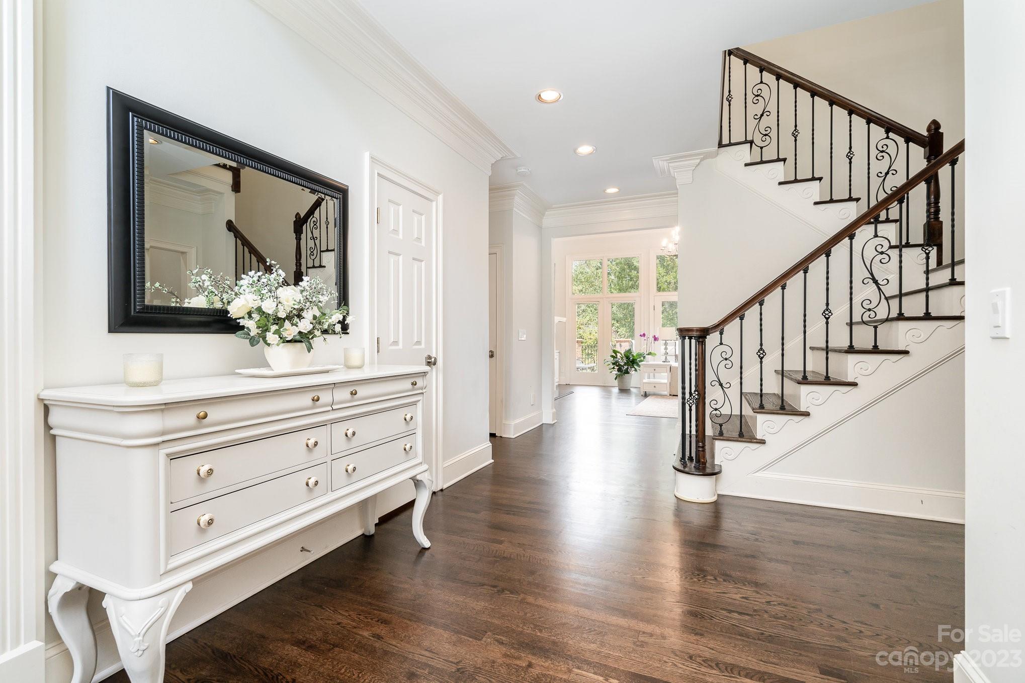 6535 Seton House Lane Charlotte, NC 28277 - Photo 5 of 48 a view of hallway with wooden floor and cabinet