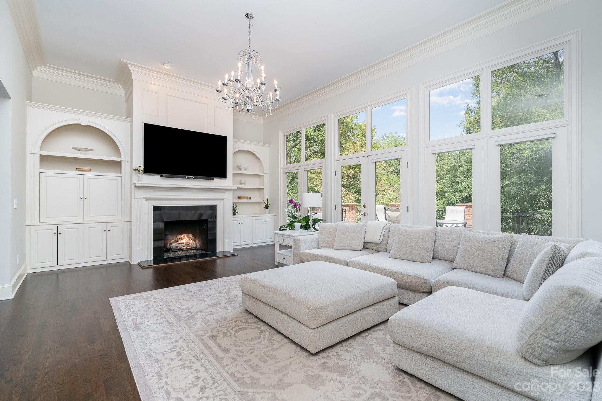 6535 Seton House Lane Charlotte, NC 28277 - Photo 10 of 48 a living room with furniture a flat screen tv and a fireplace