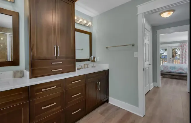 a spacious bathroom with a granite countertop sink and a mirror