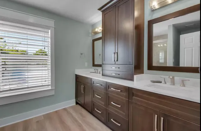 a bathroom with a double vanity sink and a mirror
