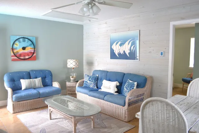 a living room with furniture and wall paintings