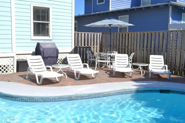 a view of a patio with a table and chairs