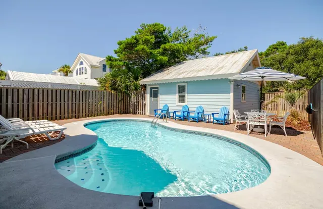 a view of a house with swimming pool and porch