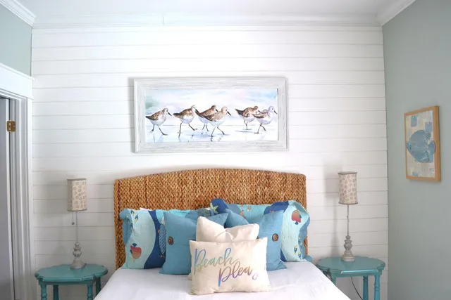 a bed sitting in a bedroom next to a bathroom with a small tub