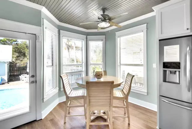 a view of a dining room with furniture window and wooden floor
