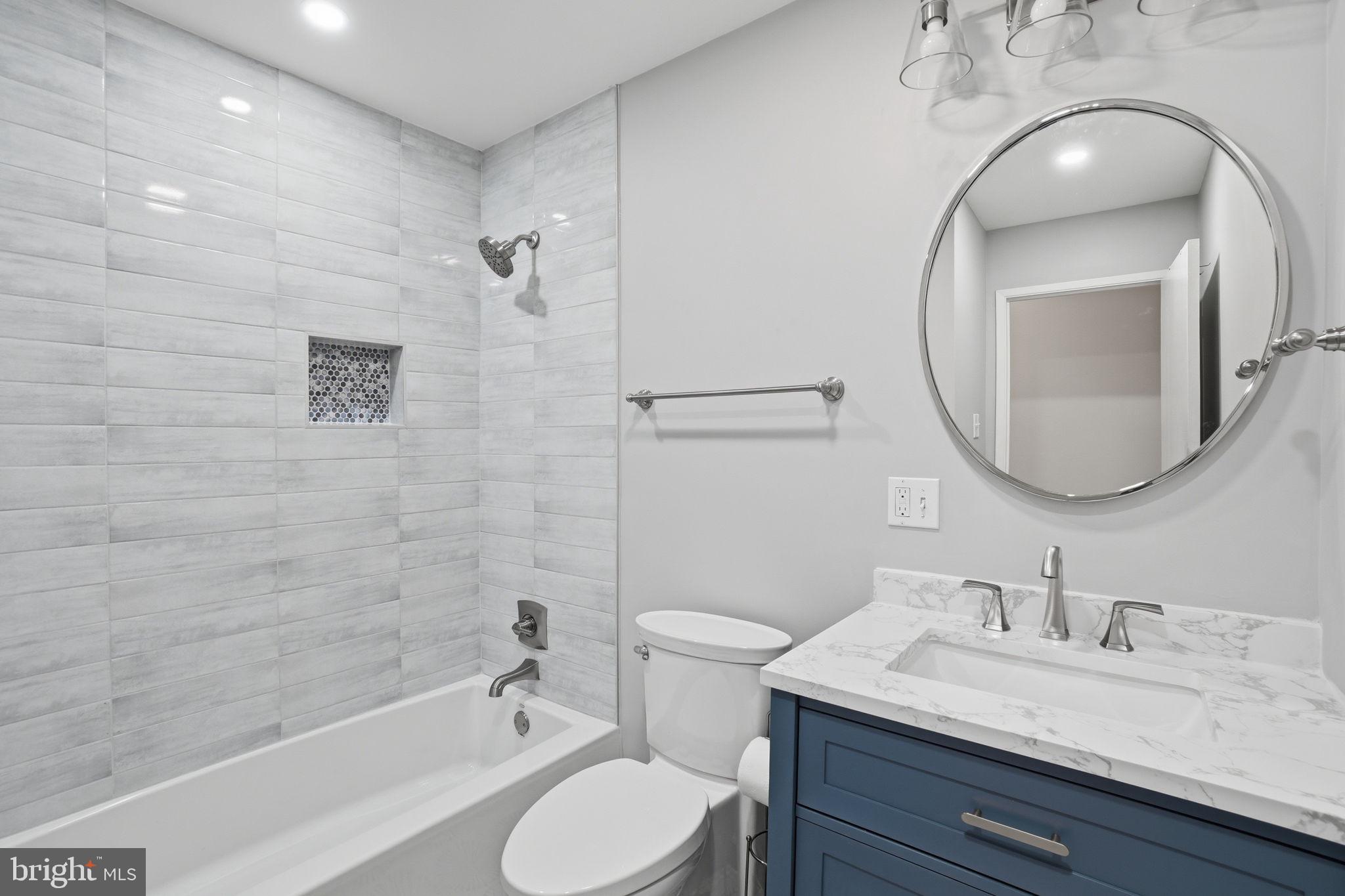 5304 Pillow Lane Springfield, VA 22151 - Photo 10 of 32 a bathroom with a granite countertop sink mirror vanity and toilet