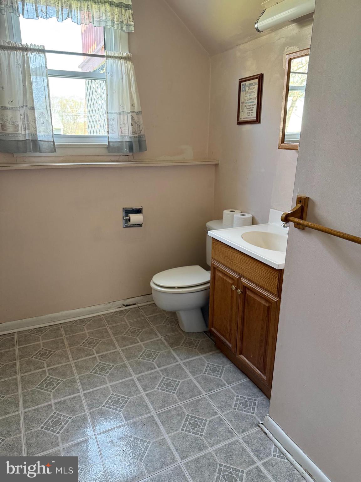 127 Stave Mill Road Bridgeton, NJ 08302 - Photo 23 of 28 a bathroom with a toilet a sink a mirror and a window