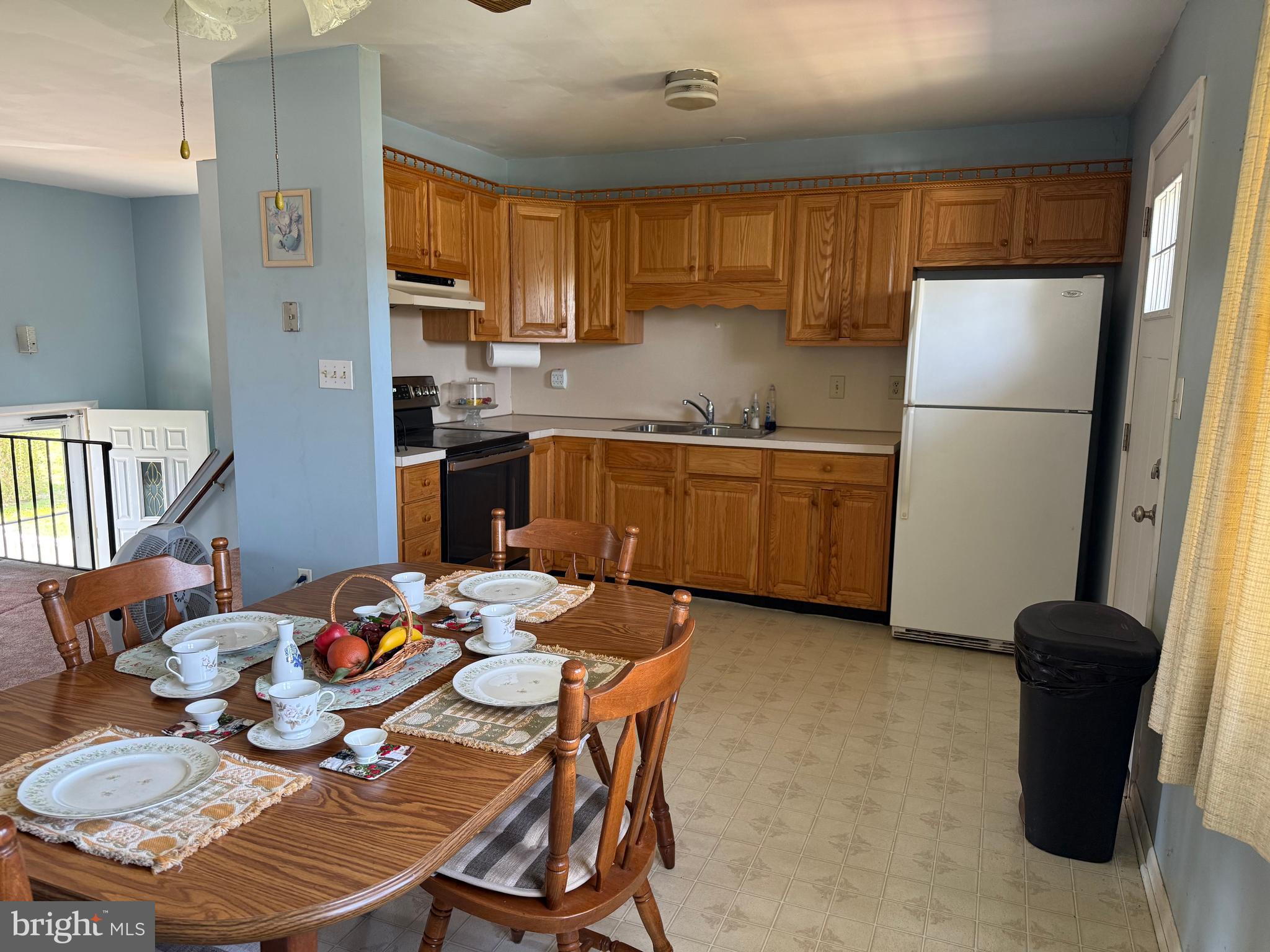127 Stave Mill Road Bridgeton, NJ 08302 - Photo 10 of 28 a kitchen with stainless steel appliances granite countertop a refrigerator a stove top oven a sink a dining table and chairs with wooden floor