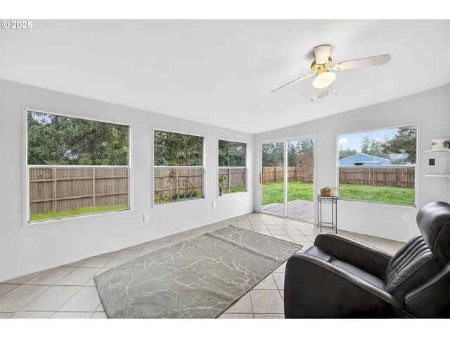 a living room with furniture and a floor to ceiling window