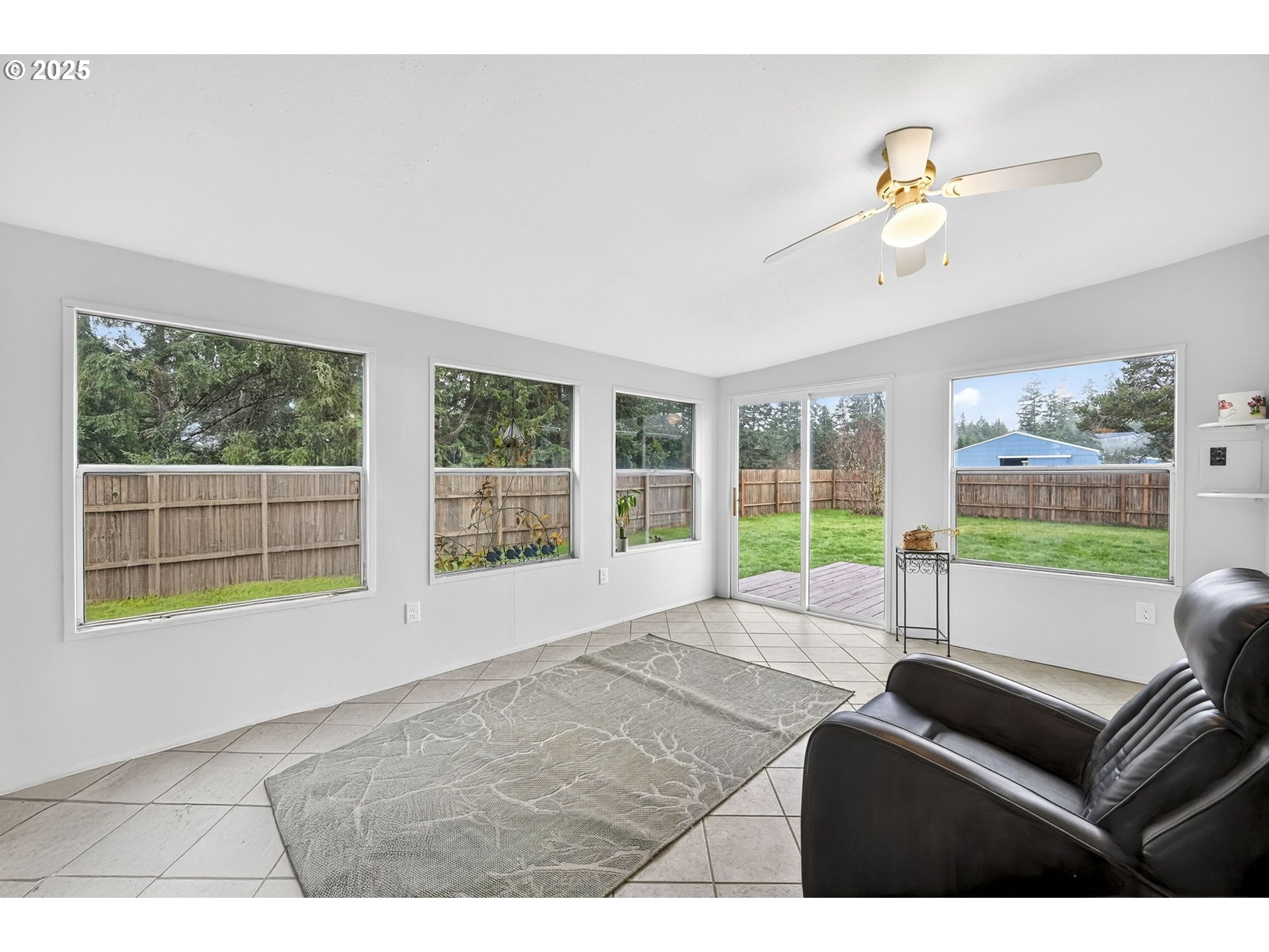 416 Coulson Road Chehalis, WA 98532 - Photo 29 of 46 a living room with furniture and a floor to ceiling window