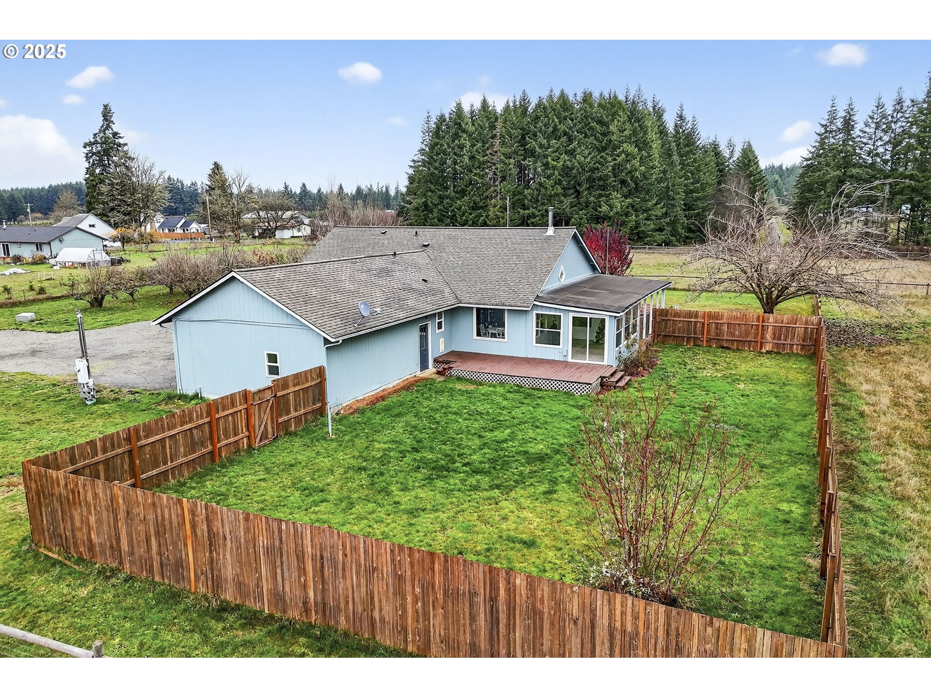 416 Coulson Road Chehalis, WA 98532 - Photo 43 of 46 a aerial view of residential house with wooden fence and trees in the background