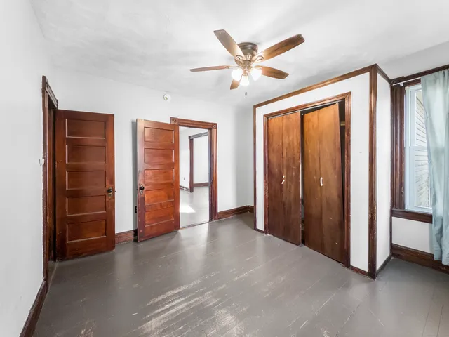 a view of a livingroom with wooden floor and entryway